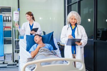 Obraz premium Two female doctors examine a patient lying on a hospital bed,discuss the medical chart,administer medicine,and provide encouragement, ensuring compassionate care and fostering the patient's recovery
