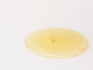 Yellow ampoule cosmetics on a gray background