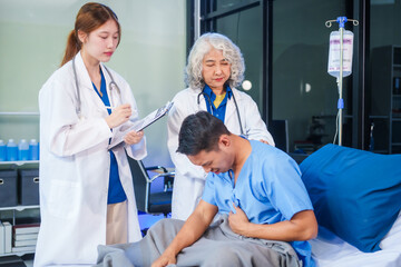 Obraz premium Two female doctors examine a patient lying on a hospital bed,discuss the medical chart,administer medicine,and provide encouragement, ensuring compassionate care and fostering the patient's recovery