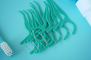 Dental Floss Picks Placed Aesthetically on a Blue Background for an Appealing Visual