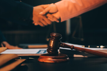 Judge gavel with Justice lawyers having team meeting at law firm background. Concepts of Law and...