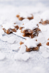 Christmas cookies (cinnamon stars) on bright background. Close up.