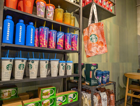 France, Bordeaux, 05 October 2024 : Starbucks merchandise display featuring colorful tumblers and branded bag