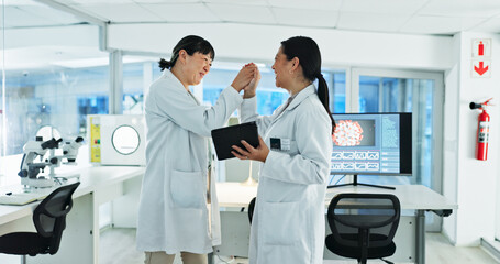 Fototapeta premium Scientist, women and high five for research, success and experiment results or medical information. Breakthrough, celebration and lab technician with tech for virus development or pathology test