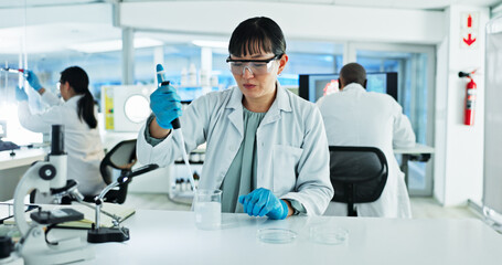 Scientist, woman and solution with pipette, petri dish and sample preparation in biotech laboratory. Biochemistry, bacteria and research with technician for DNA study, genetic innovation or results