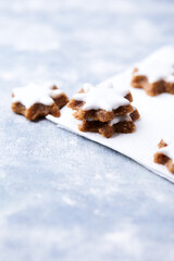 Christmas cookies (cinnamon stars) on bright background. Close up.