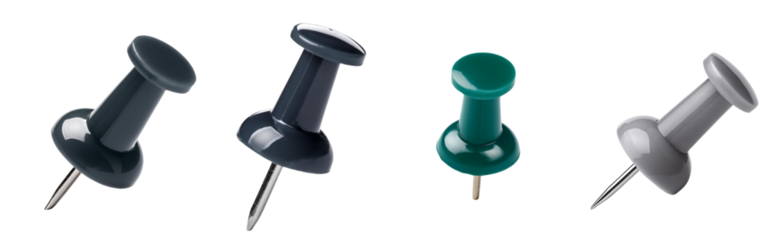 Collection of colorful push pins on a white isolated background.