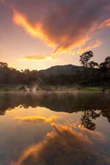 Hot springs over rock terrain with misty and morning sunrise rays and Natural Mineral Water of Chae Son National Park in Lampang Province, Thailand.