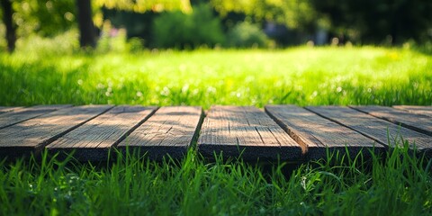 Summer background featuring a wooden table amidst vibrant green grass, creating a perfect summer background for outdoor gatherings and leisure activities. Enjoy the refreshing summer background.