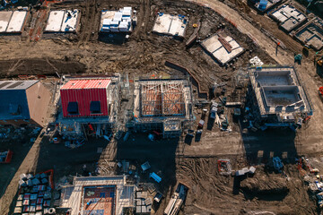 Aerial view from drone at Construction of multiple residential buildings in a developing neighborhood during daylight hours