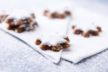 Christmas cookies (cinnamon stars) on bright background. Close up.