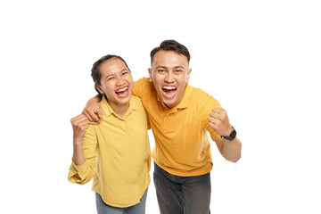 Fototapeta premium Happy Asian couple hugging each other while raising their fist hands