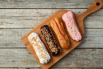 Assorted eclairs on a pastel top view Traditional French dessert