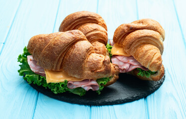 Croissant sandwich with salad ham and cheese . Top view