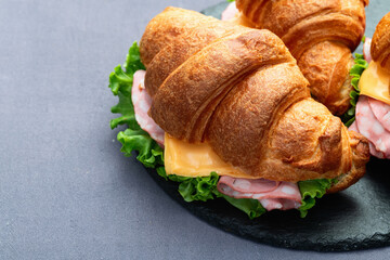 Croissant sandwich with salad ham and cheese . Top view