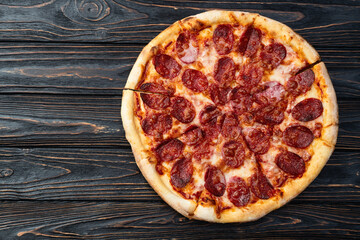 Pizza pepperoni fast food . Top view on rustic background