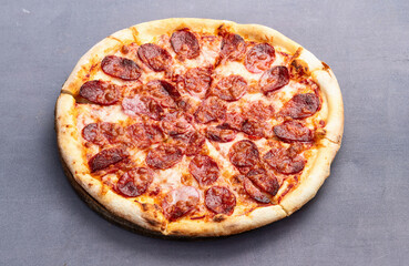 Pizza pepperoni fast food . Top view on rustic background