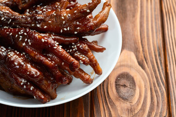 Caramelized korean or Chinese chicken foots ( paws ) with sesame . Top view