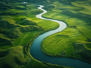 aerial view of a winding river through lush green fields