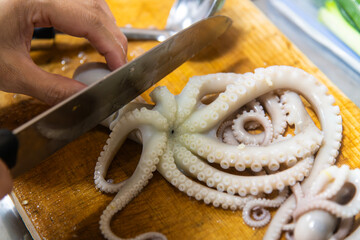 boiled octopus on the cutting board with knife and ladle © 안구정화