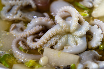 boiling seafood stew with octopus and vegetables