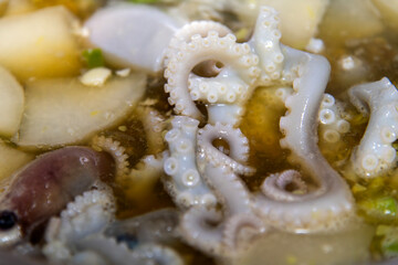 boiling seafood stew with octopus and vegetables