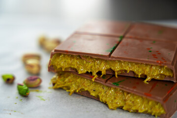 Trend Dubai chocolate with pistachio paste and kataifi dough. Confectionery handmade sweets at home in the kitchen. 