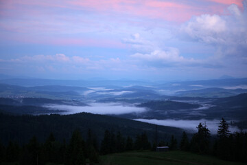 Landscape of Zywiec Beskids mountain range after sunset, view from Rysianka peak, Poland