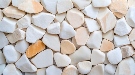 Many clean rounded stones are displayed closely together, showcasing their smooth textures and varied earth tones. The arrangement highlights the natural beauty of these stones.