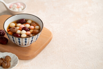 Homemade red and white tangyuan with syrup soup, dried longan pulp, red dates for Winter solstice.