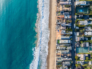 Aerial Coastal Homes Overlooking a Vibrant Blue Ocean