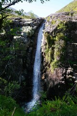 waterfall in a scottish forest im the glencoe valley near three sisters