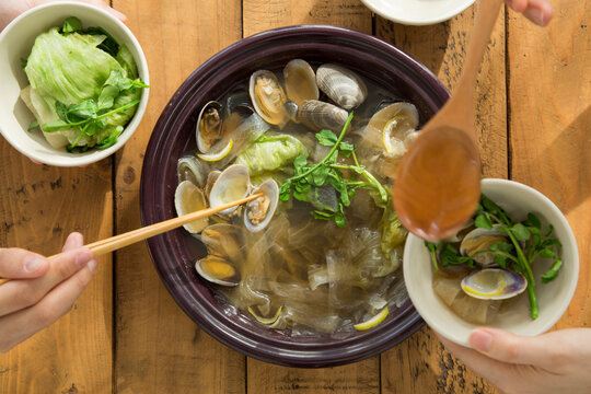 Eating Japanese-style one-pot dish of asari clam and Japanese parsley