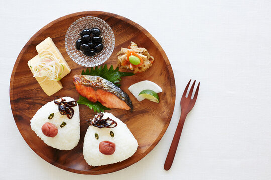 Rice balls and side dishes on a plate