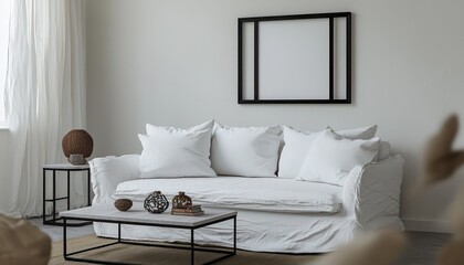 Living room with a black-framed poster mockup, snow-white sofa, and minimalist decor in soft daylight.