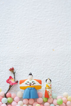 Hina dolls, hina arare and peach blossoms on washi paper