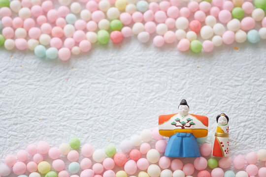 Hina dolls, hina arare and peach blossoms on washi paper