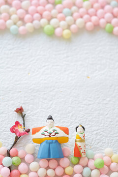 Hina dolls, hina arare and peach blossoms on washi paper