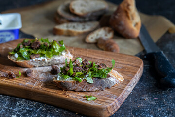 sliced bread on cutting board, ready to make open-faced sandwich