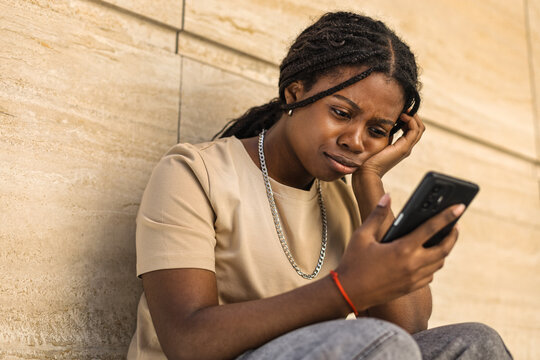 Young African American frustrated and upset outdoors urban building