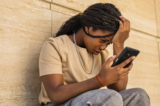 Young African American frustrated and upset outdoors urban building