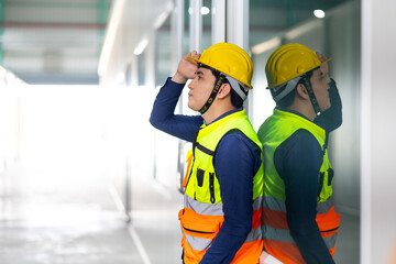 Tired hot wiping sweat. Asian man Warehouse staff Employees worker standing by goods shelf working in large warehouse. transport and storage of goods. supply chain and delivery