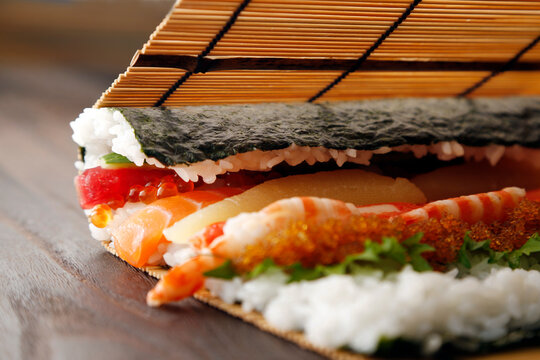 Photo of the process of rolling up the seafood futomaki.