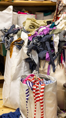 Generated imagFabric scraps and textile remnants in a sewing workshop stored in large bags....