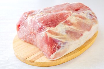 Pieces of  Pork in cutting board on a white background,	