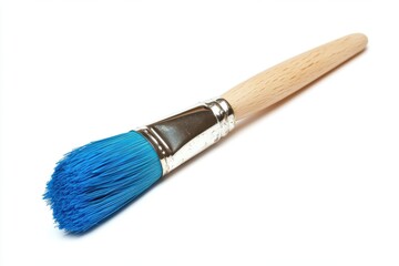 Fototapeta premium A wooden handled paintbrush with vibrant blue bristles and a metallic ferrule securing the bristles