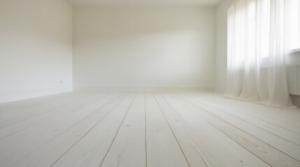 Empty room with whitewashed wood flooring and newly painted white wall in background