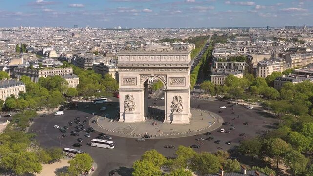 PARIS, FRANCE - OCTOBER 3, 2024: Stunning aerial view of Arc de Triomphe and bustling traffic at Champs-Elysees during a bright afternoon