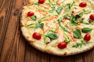 Italian pizza with avocado salmon  tomatoes and mozzarella photography. top view