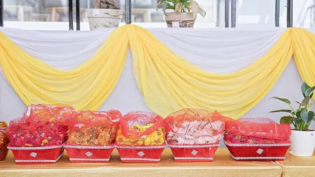Closeup shot of various flowers arranged in baskets for worship at the religious event